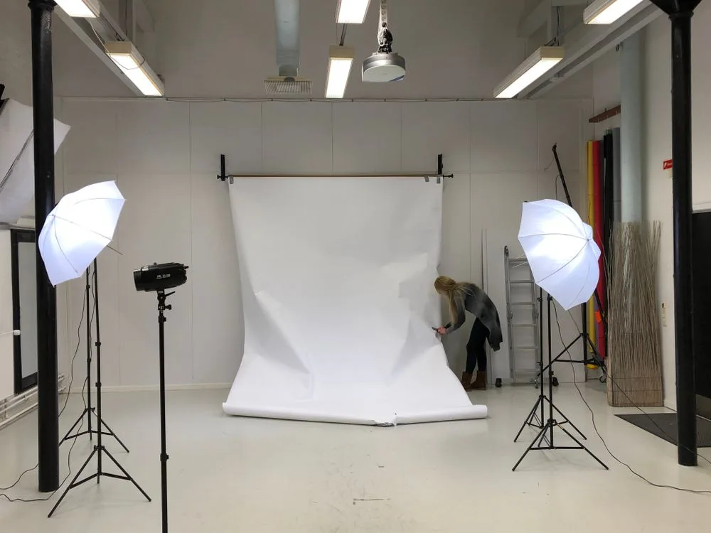 Photographer working with a model in a professional studio setting — inspiration for studio photo sessions